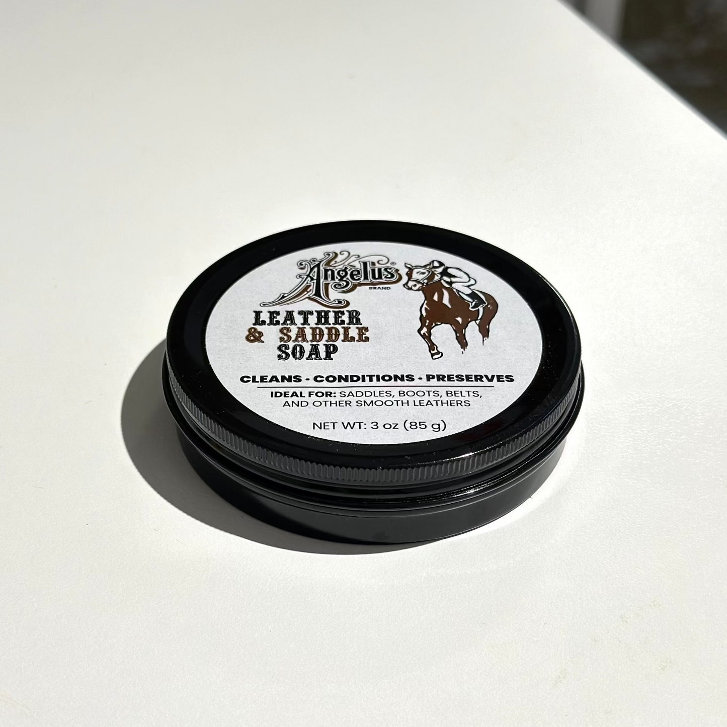 Jar of leather and saddle soap on a white surface