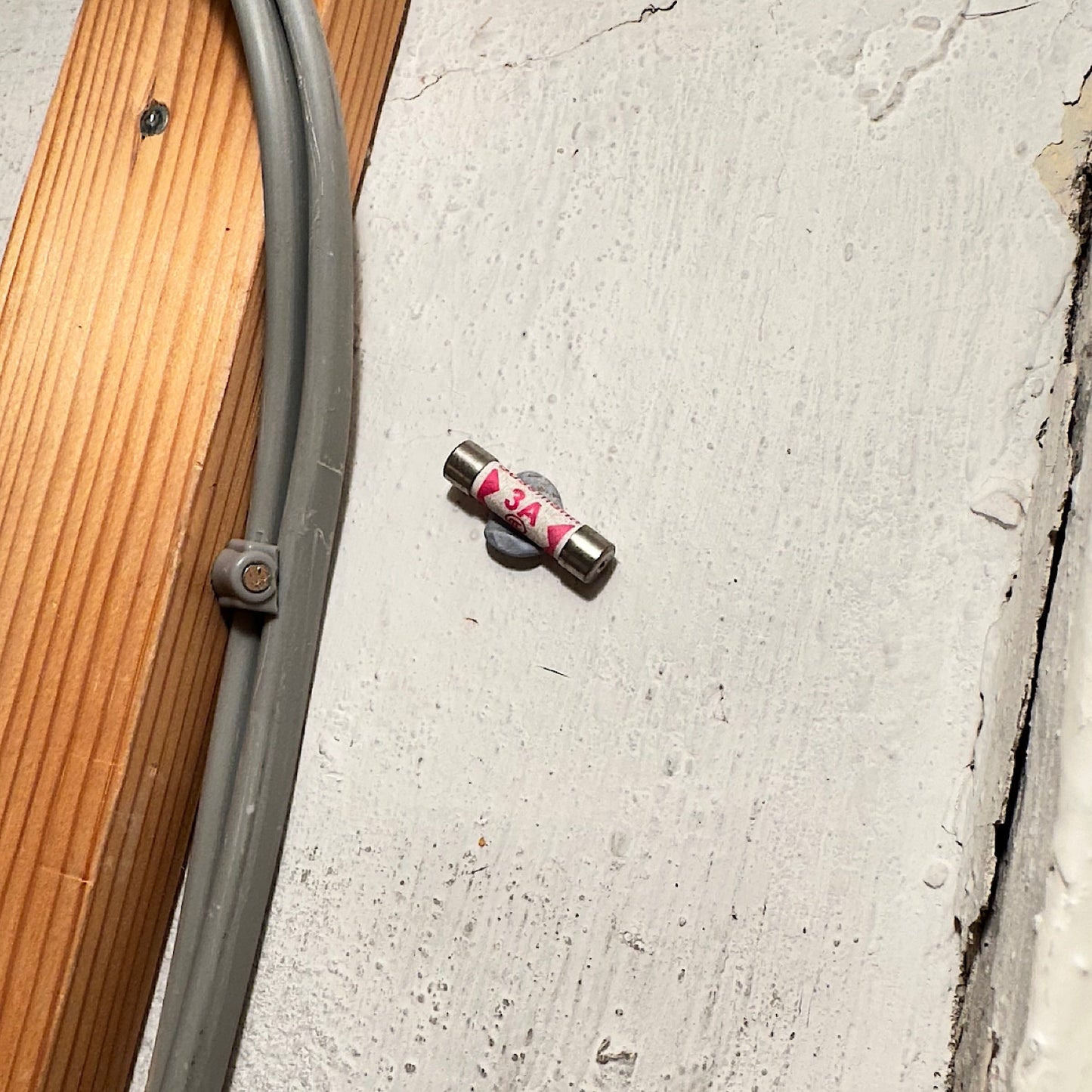 3 amp fuse stuck to the wall with blu tack