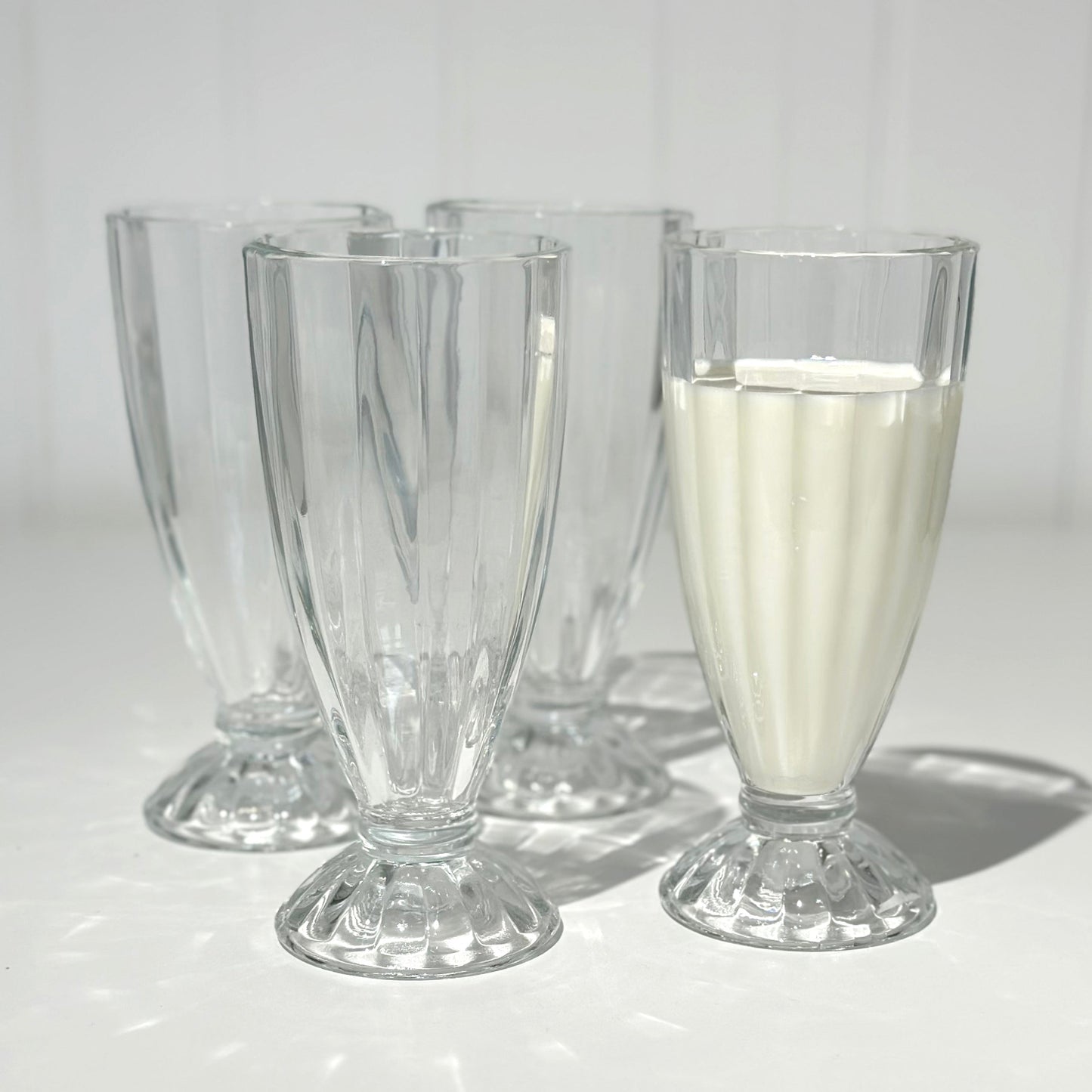 Milkshake glasses on white background one with milk