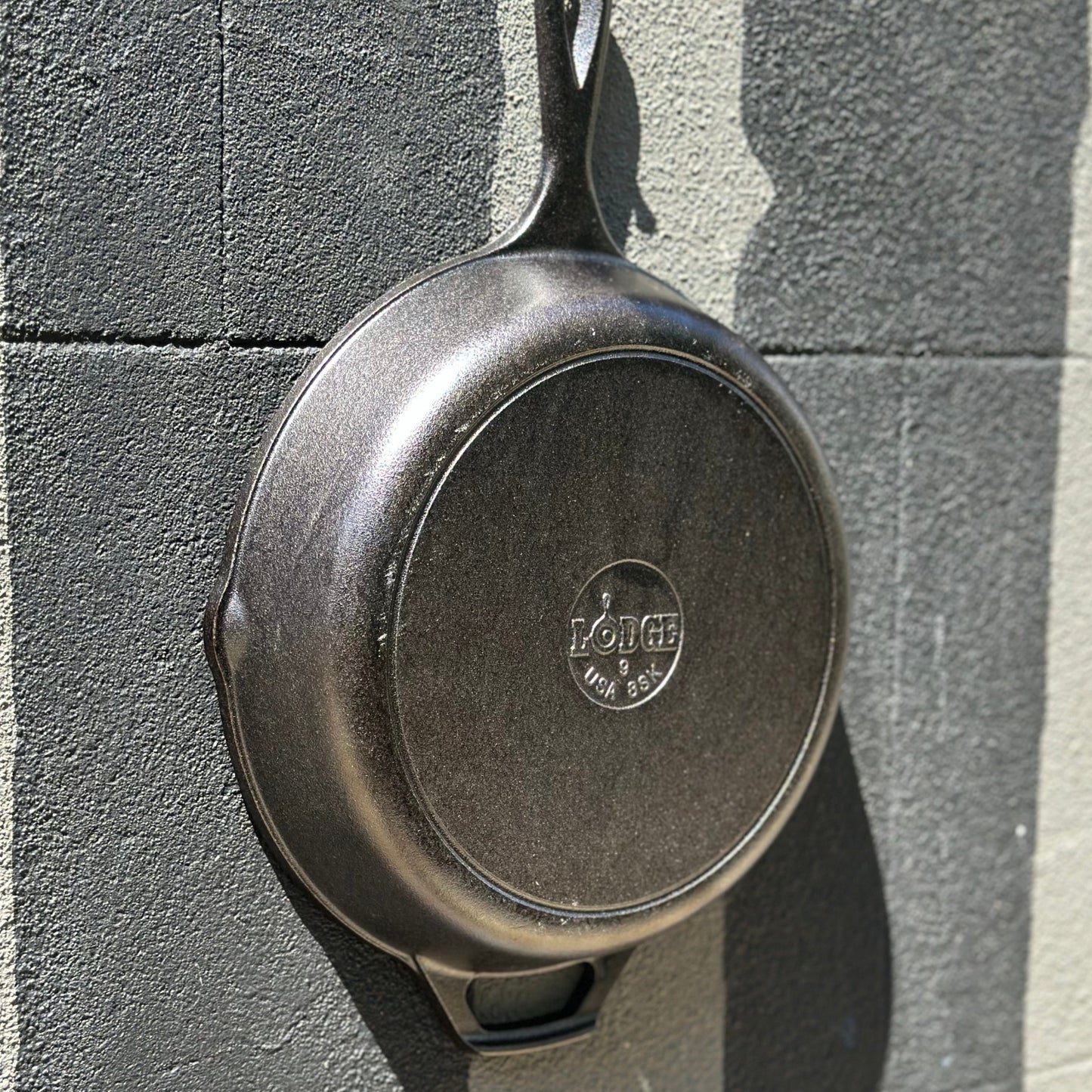 Lodge skillet back underside outdoor wall shadow