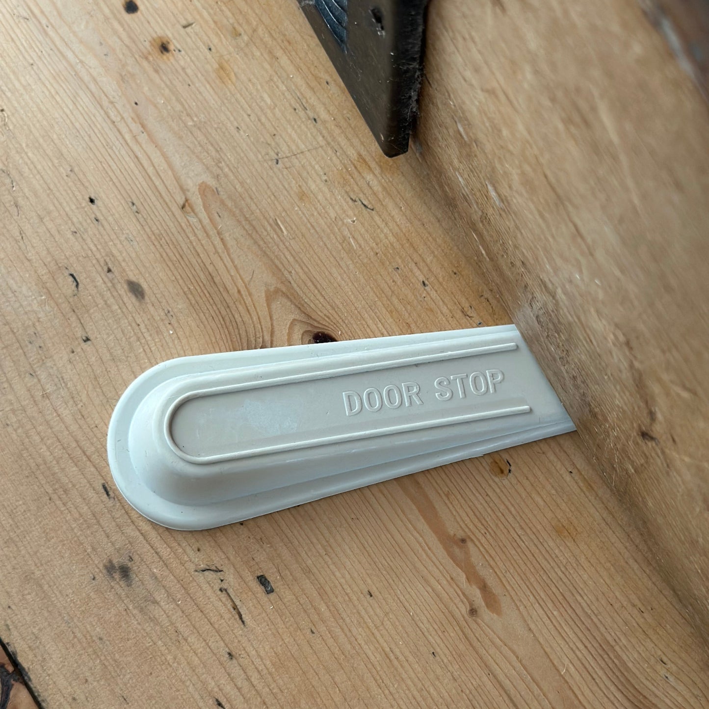 White door stopper on a wooden surface