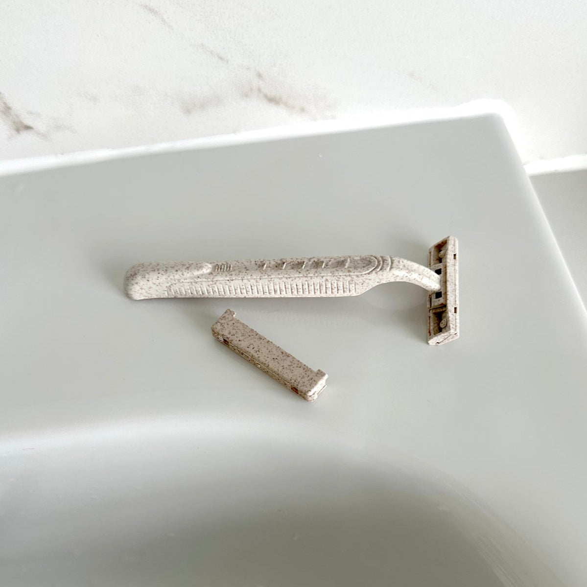 Safety razor on a white sink