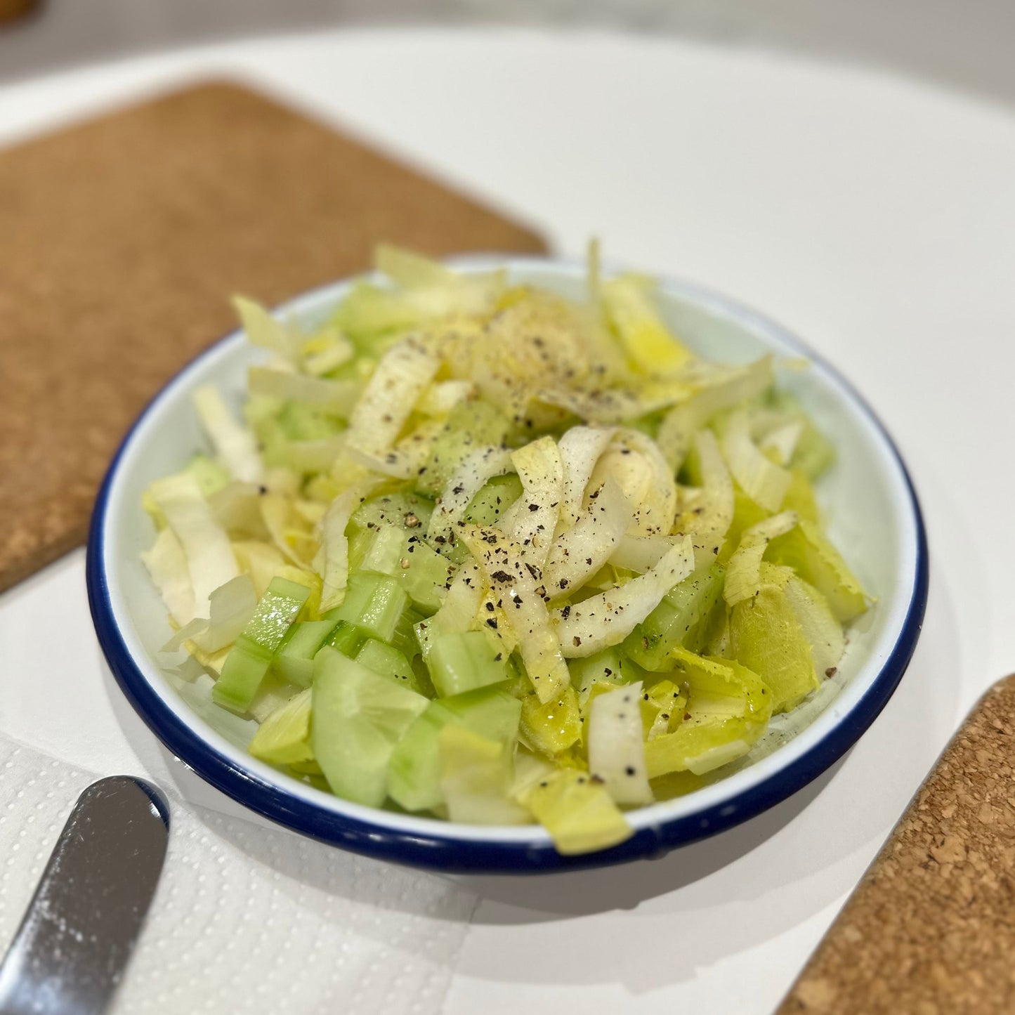 Salad in a white enamel dish
