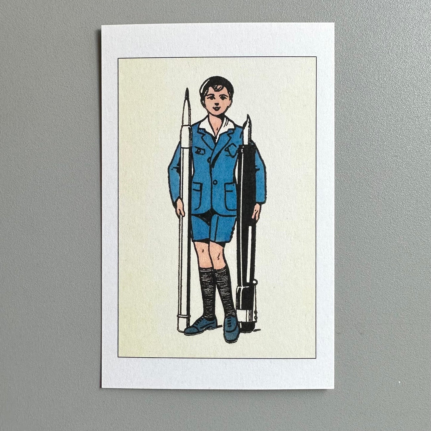 Illustration of a person in a blue uniform holding giant pen and pencil on a beige background.