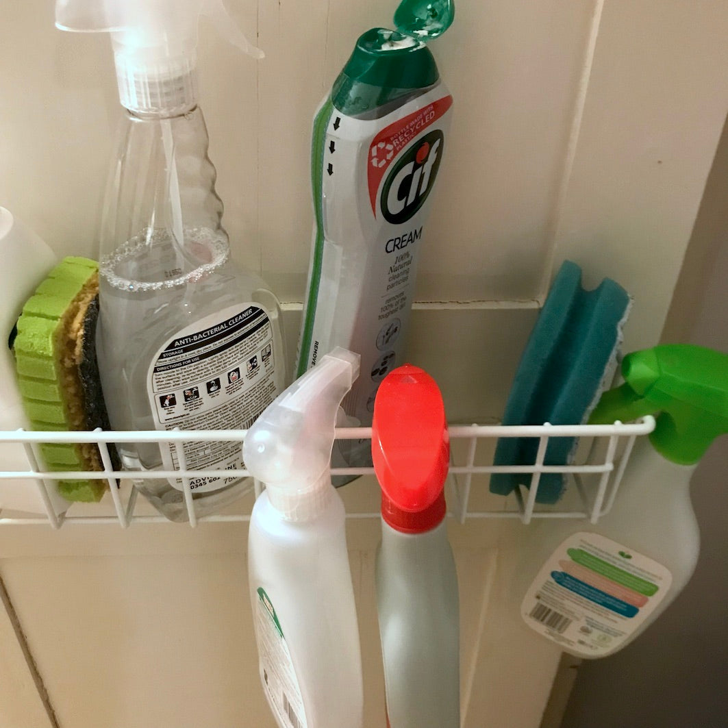 Wire shelf in cupboard bottle storage