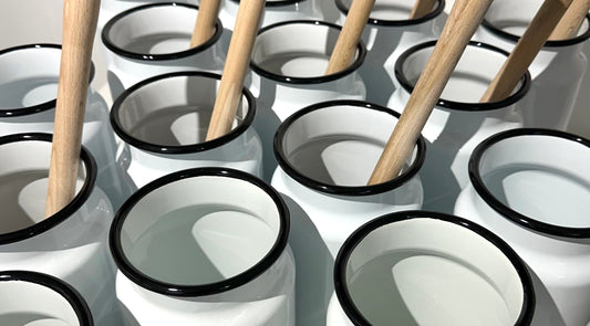 Utility enamel toilet brush holders seen from above in a group