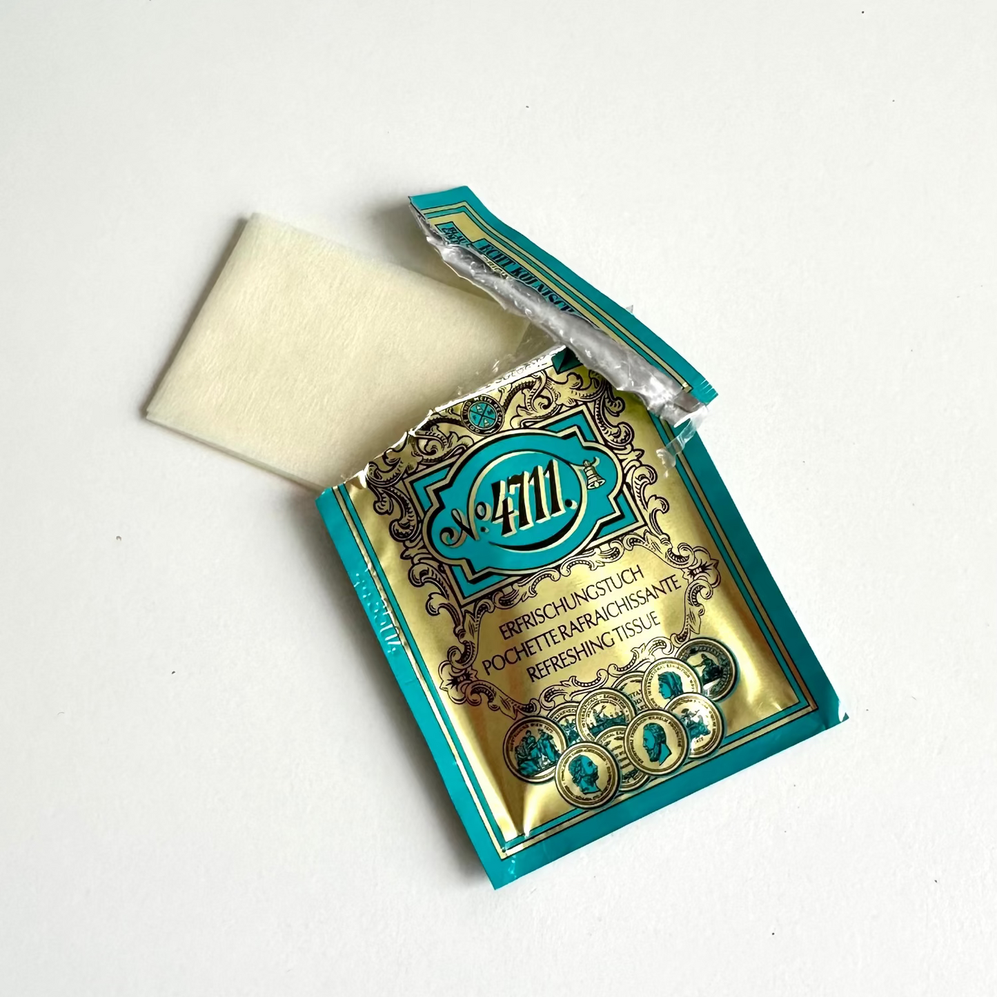 An open foil packet of 4711 tissue displayed on a clean white background.