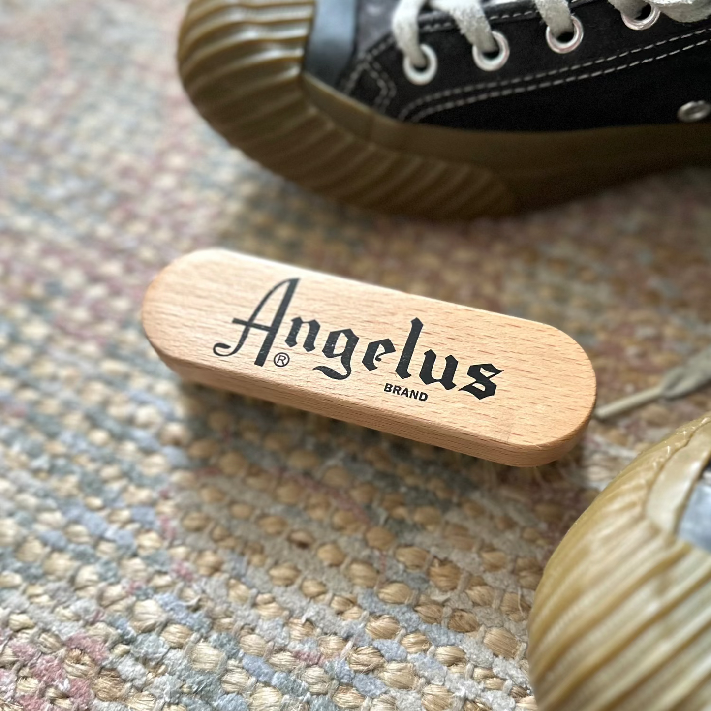 Angelus_brand_sneaker_trainer_brush on a carpet with sneakers
