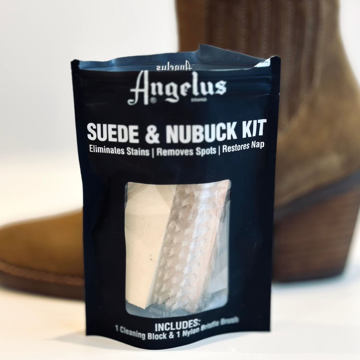 Suede and nubuck cleaning kit packaging with a background of brown shoes.