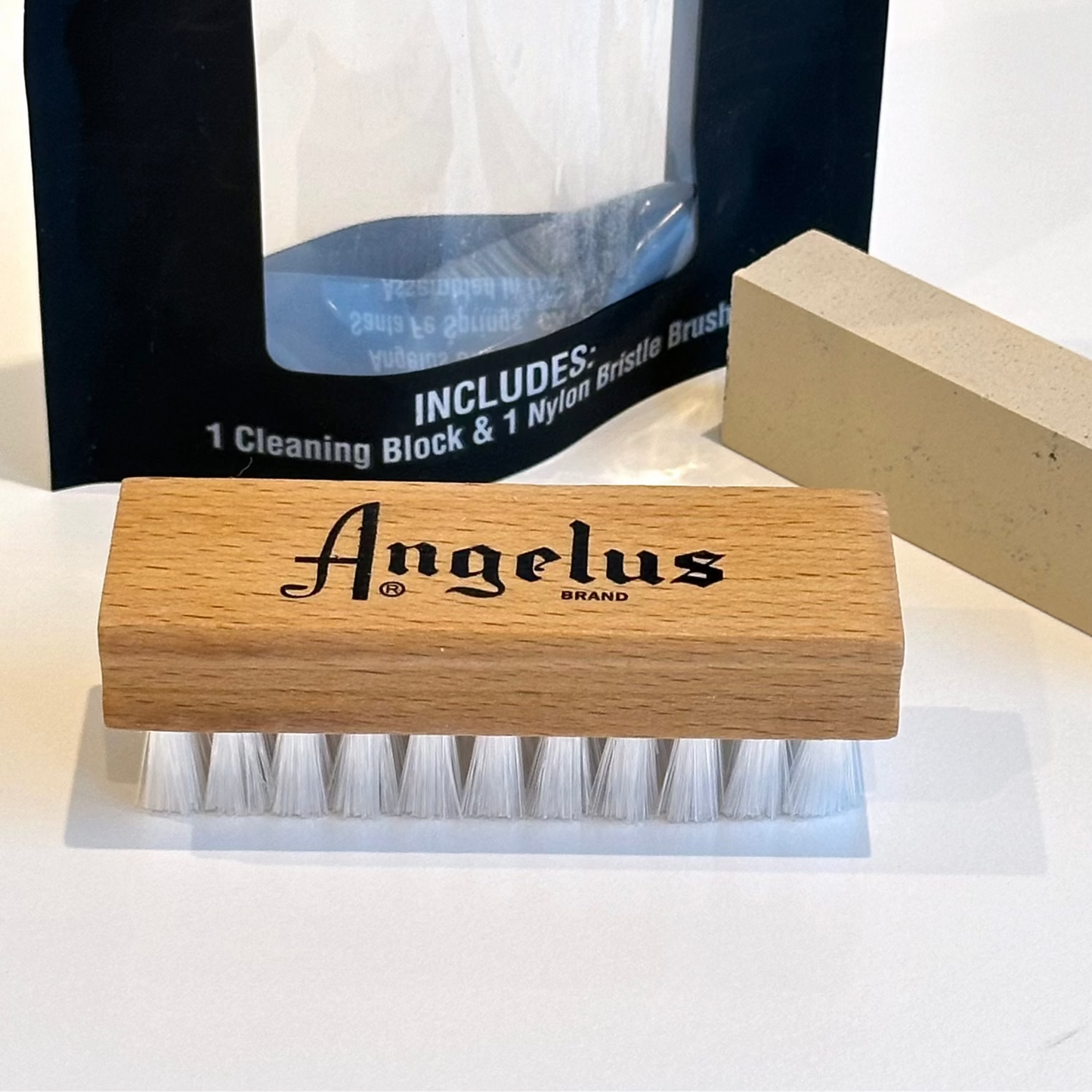 Angelus brand cleaning brush and suede cleaning block on a white background