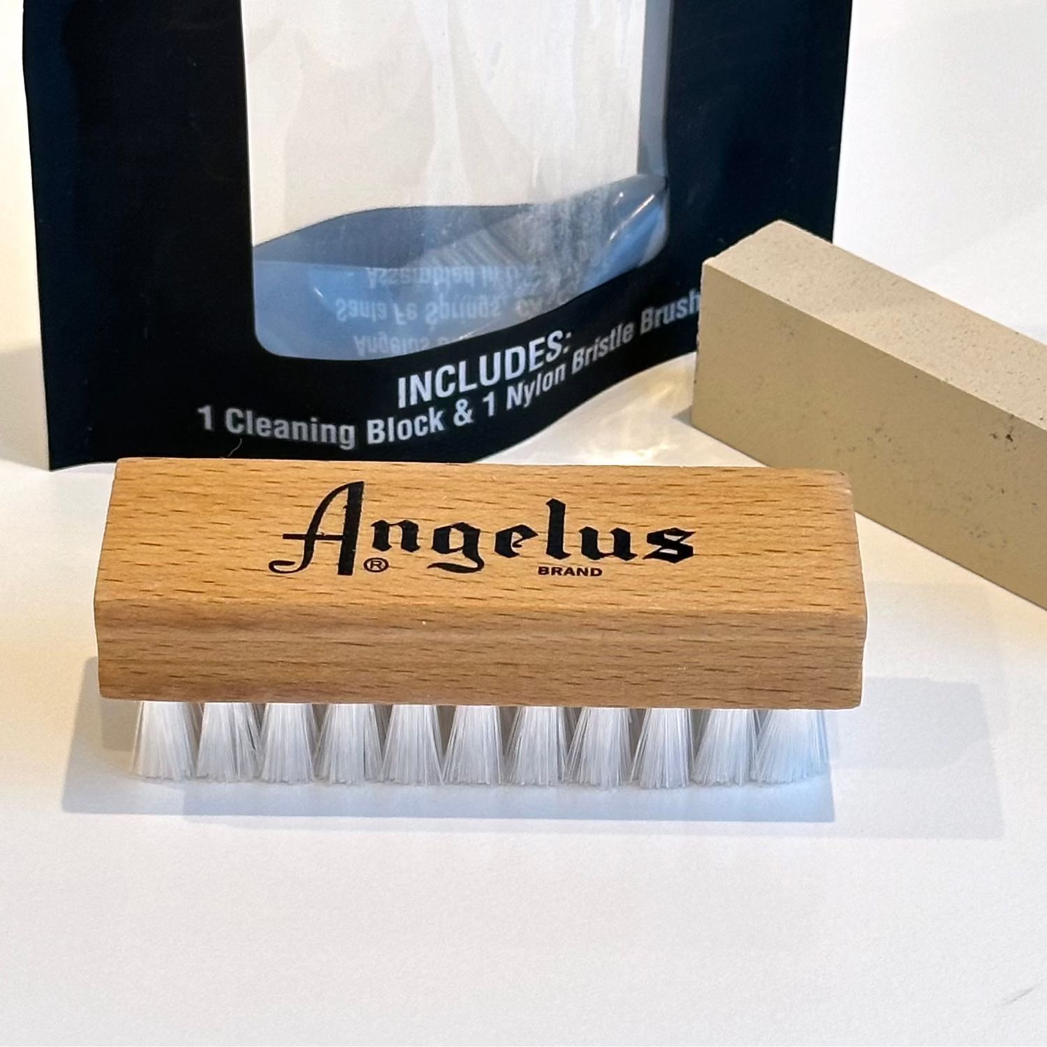 Angelus brand cleaning brush and suede cleaning block on a white background