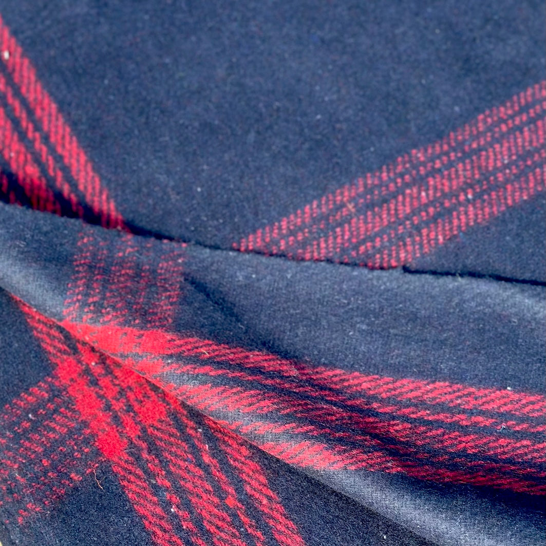 Detail of navy wool blanket with red stripe check weave