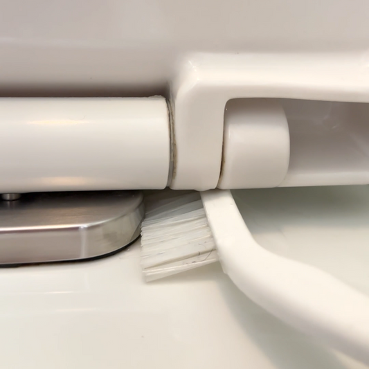 Corner brush cleaning toilet seat hinge