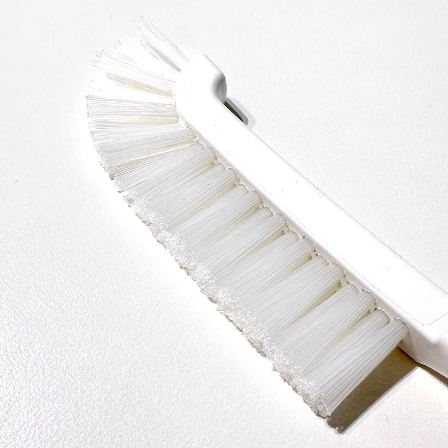 White curved brush on white background