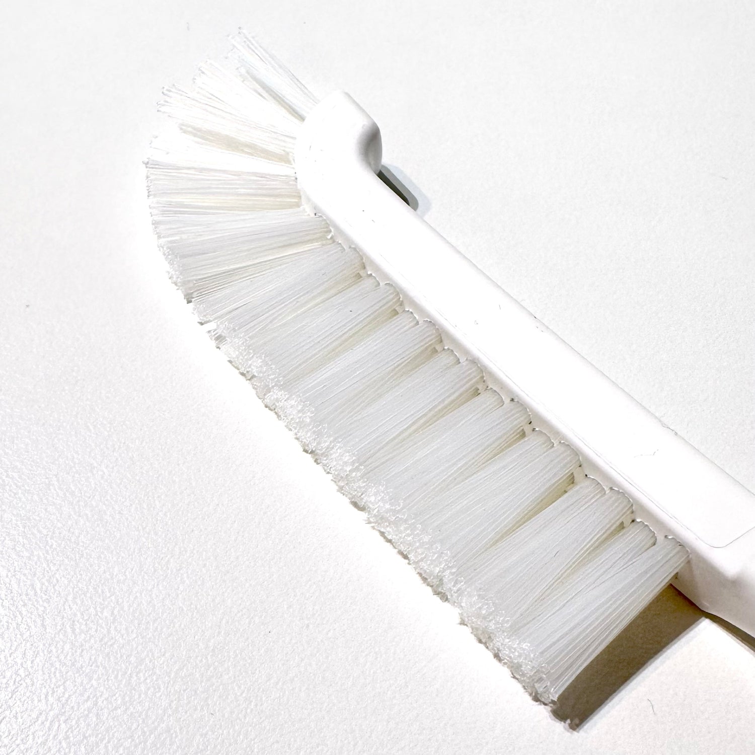 White curved brush on white background