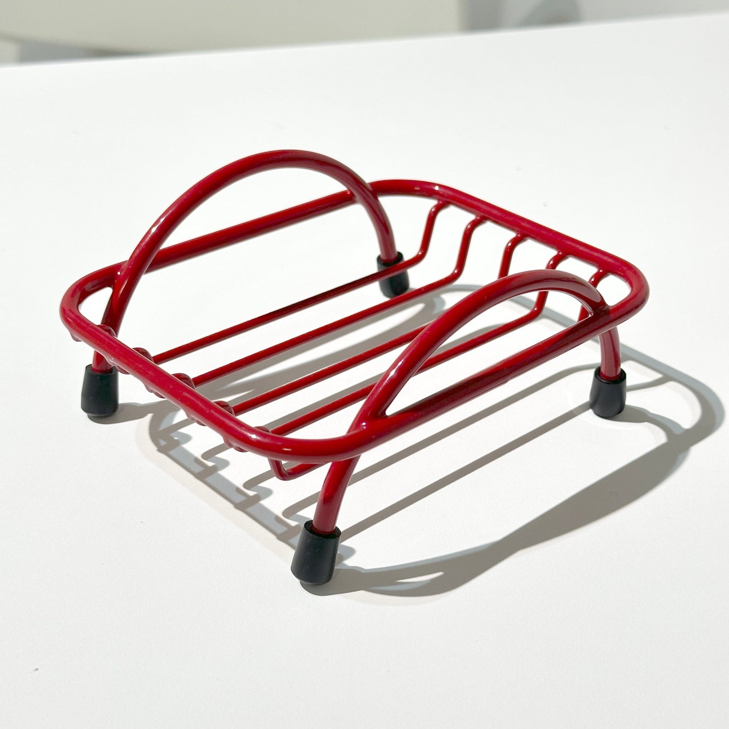 Red wire soap holder tray on white background