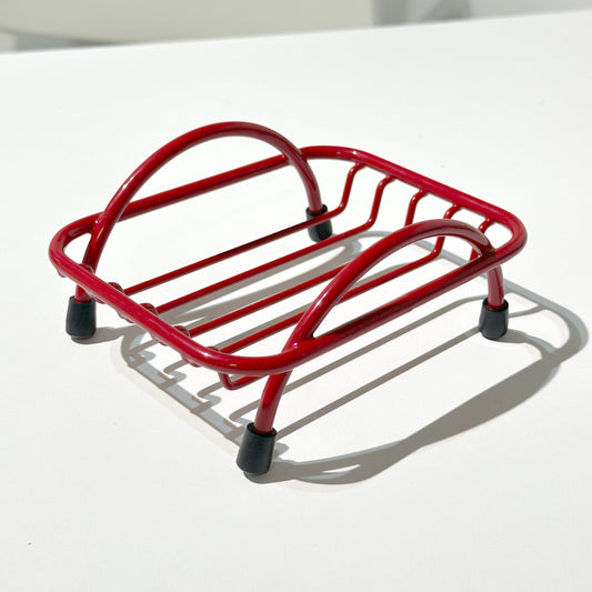 Red wire soap holder tray on white background