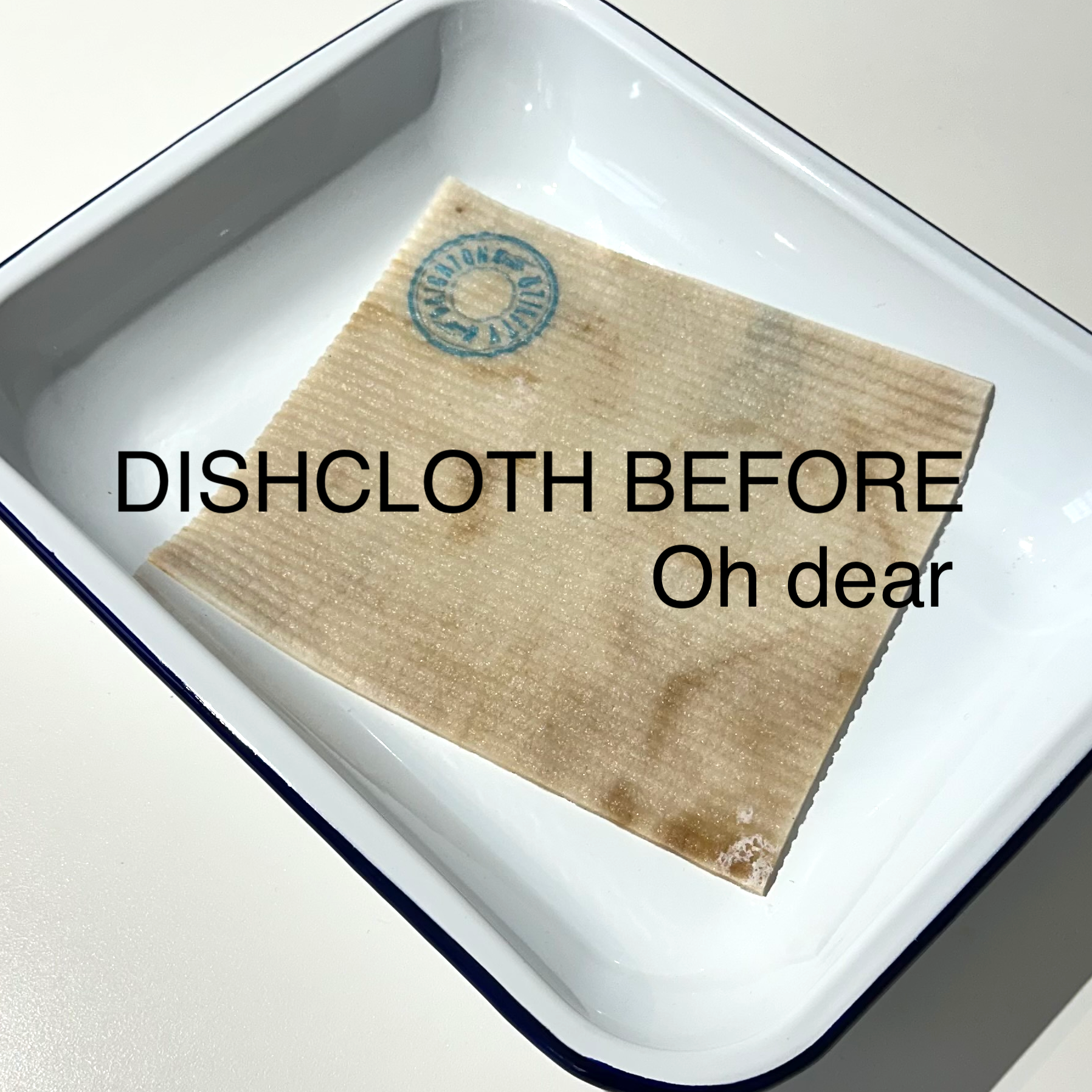 Tea stained dish cloth in white pan