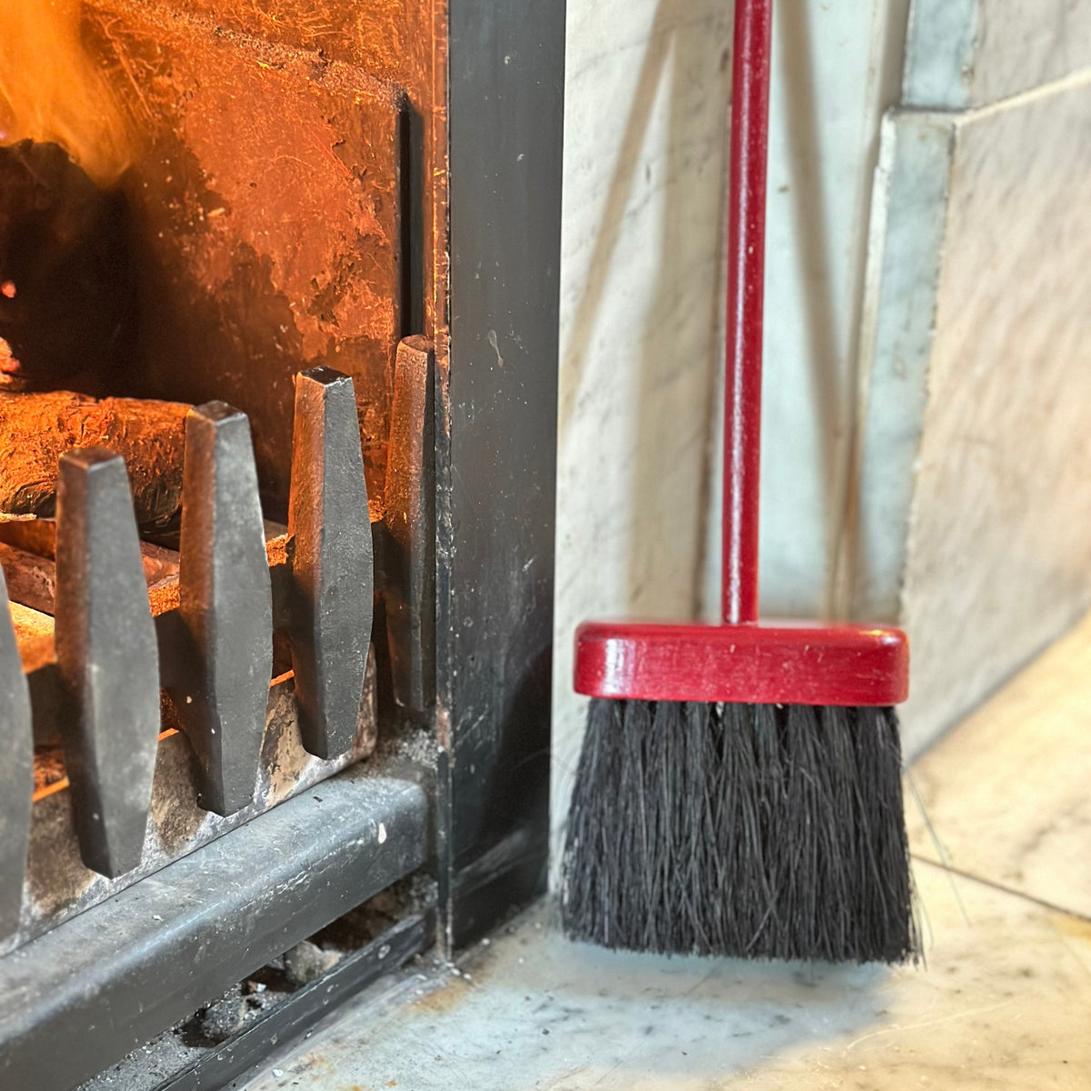 Hearth brush red by fire place