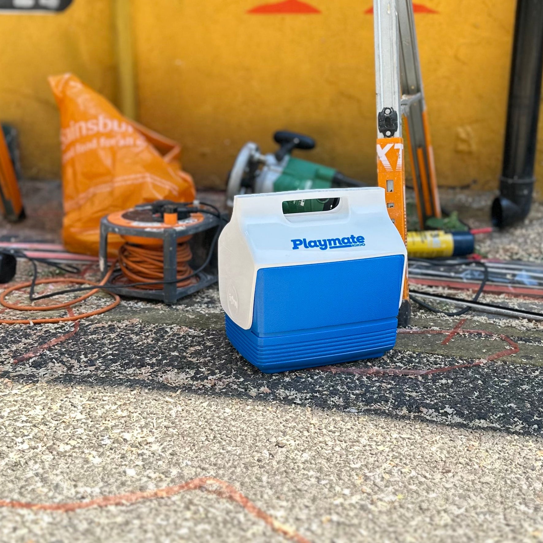 Igloo playmate coolbox on street by tools