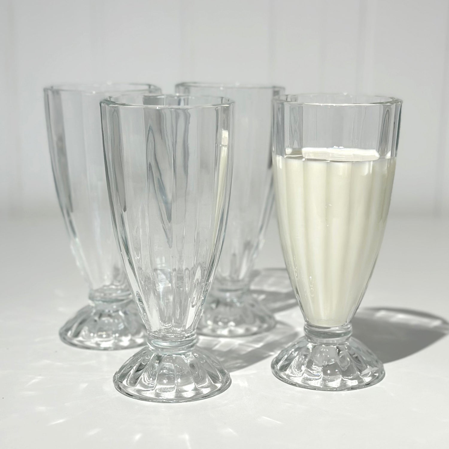 Milkshake glasses on white background one with milk
