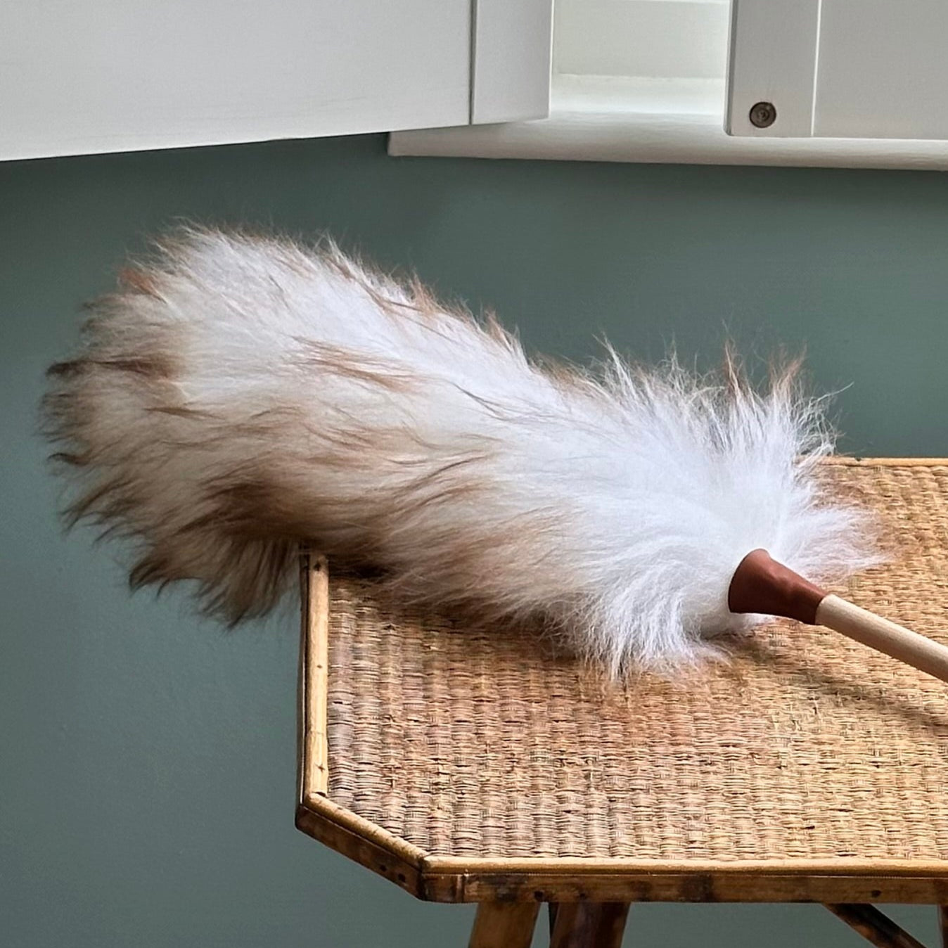 Lambswool duster on wicker table