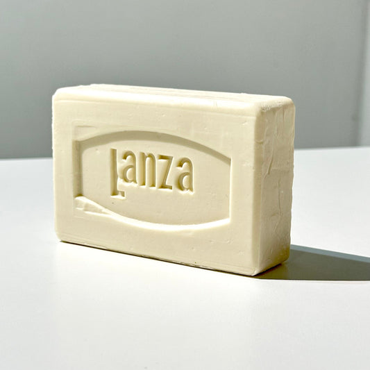 Bar of Lanza soap on a white surface with a grey background