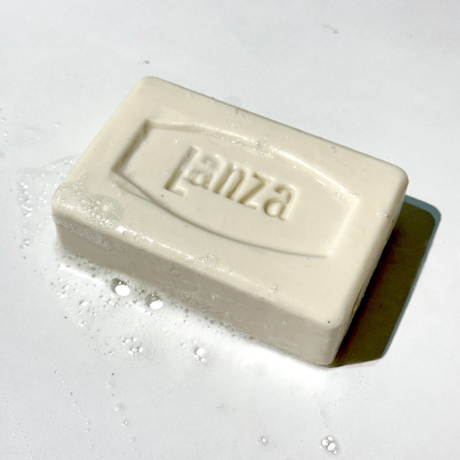 Bar of soap with suds white background