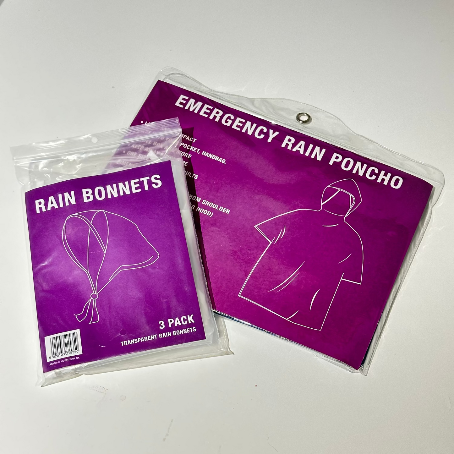 Two packages of rain accessories on a white surface, one labeled 'Rain Bonnets' and the other 'Emergency Rain Poncho'.