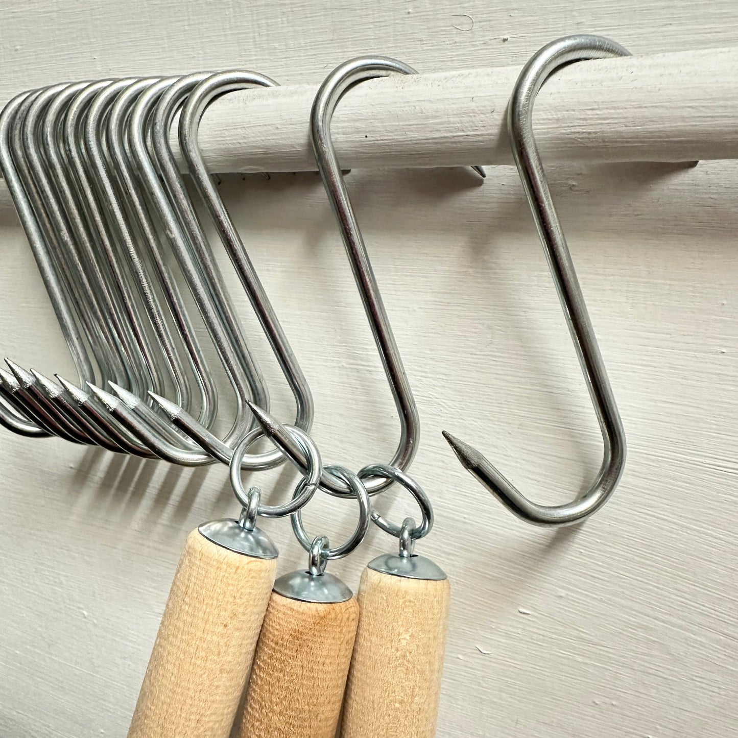Row of butchers S hooks with tools