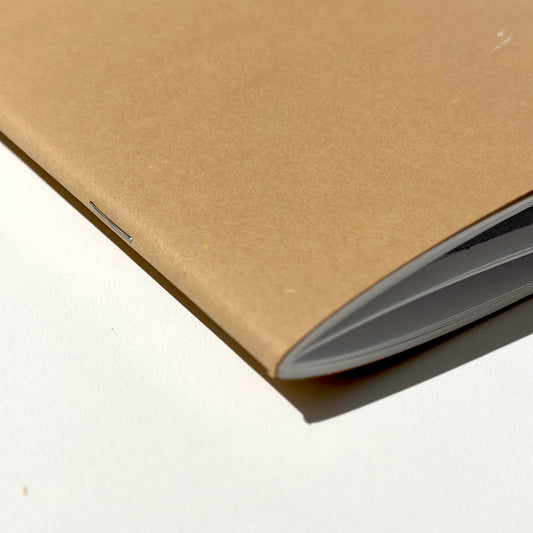 Close-up of a brown notebook on a white background