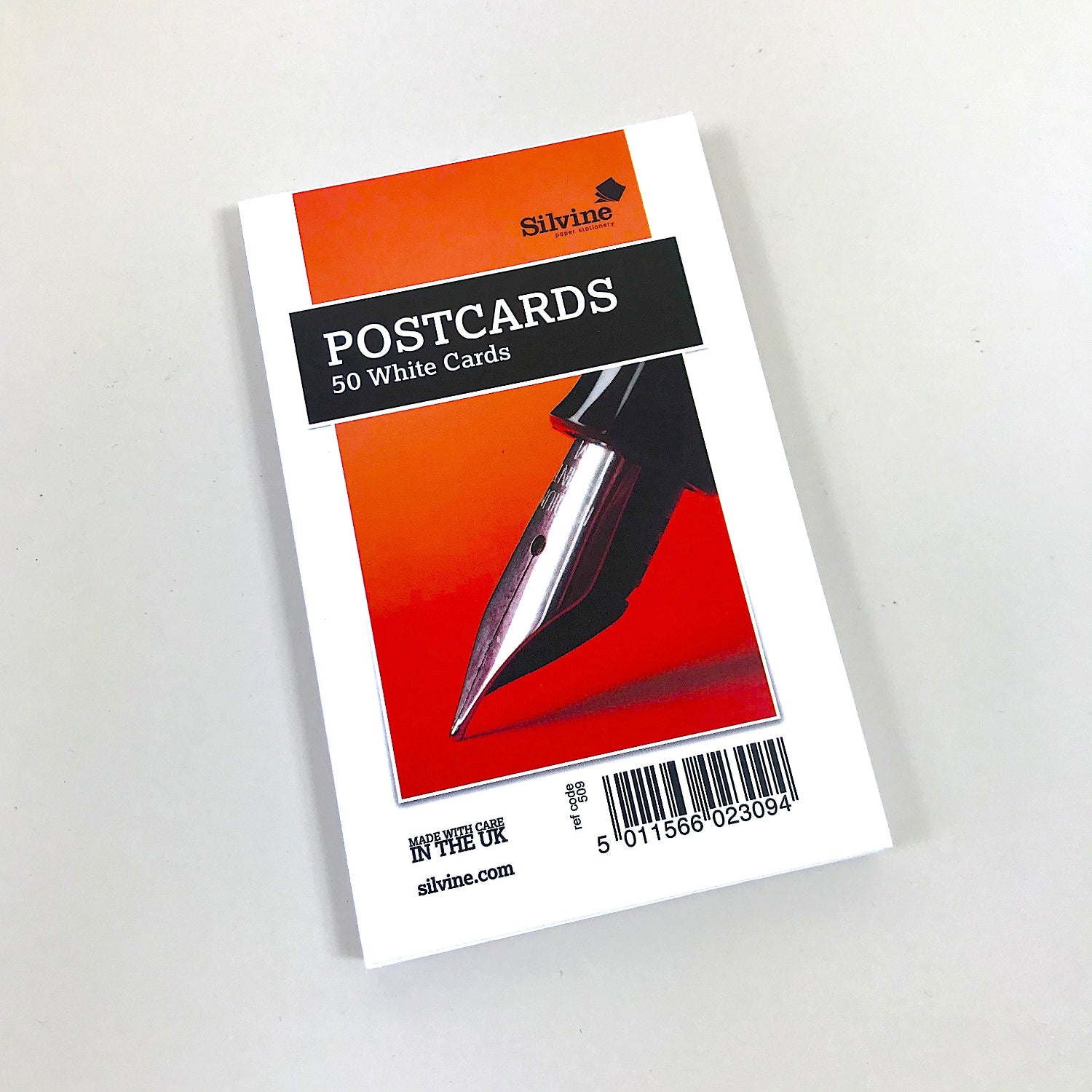 Pack of Silvine postcards with a pen on an orange background