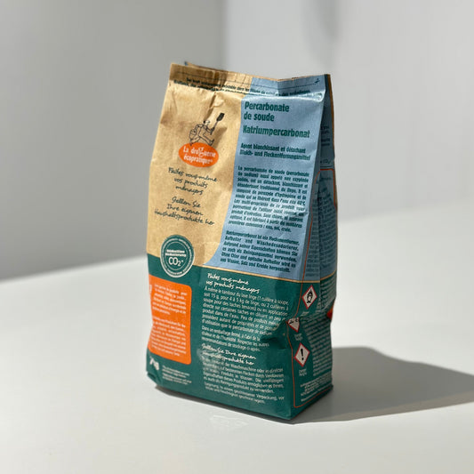 Paper bag of sodium percarbonate on a white background