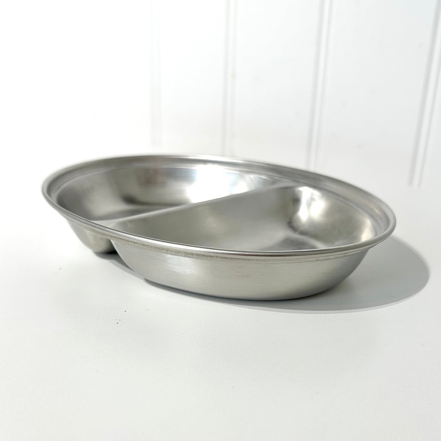Stainless steel vegetable dish on a white background