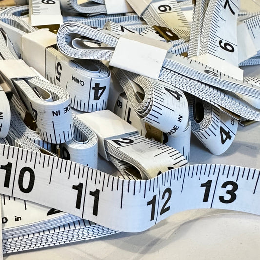 Multiple measuring tapes with numbers on a white background