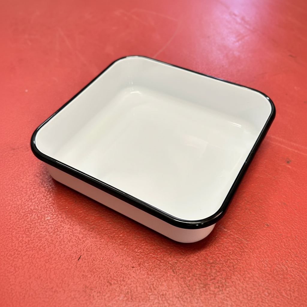 Utility enamel square pan red background. Enamel, white with black rim