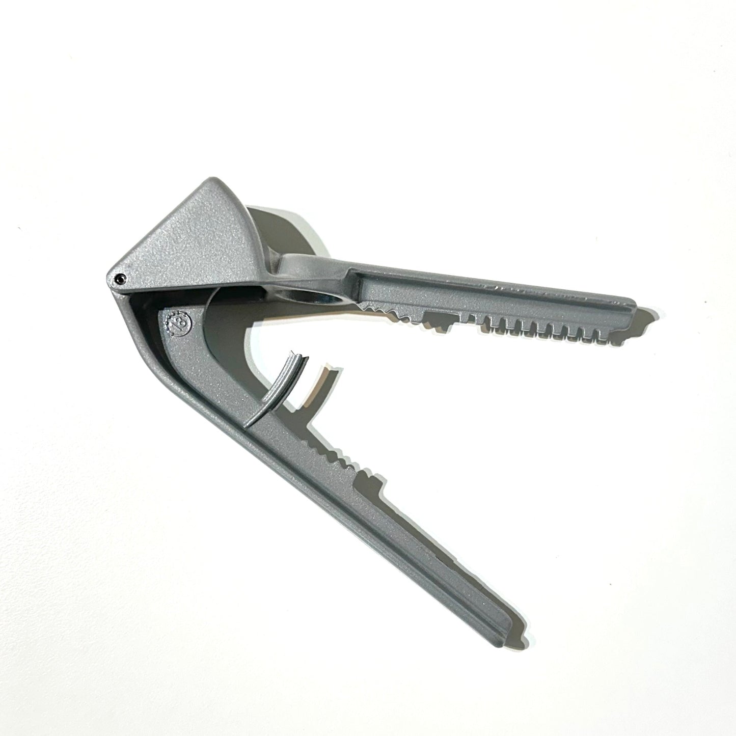 Metallic bottle opener on a white background
