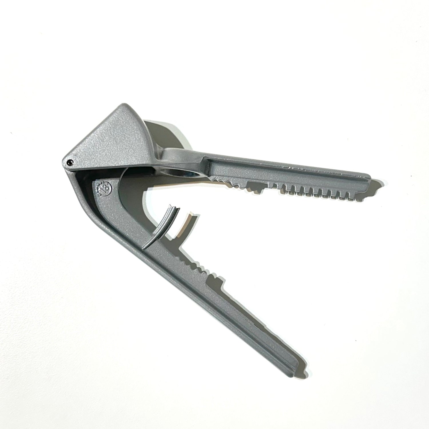 Metallic bottle opener on a white background