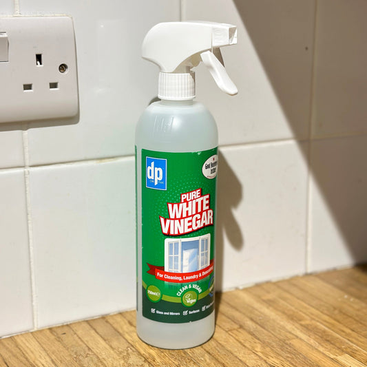 White vinegar spray bottle white tiles and wooden work top