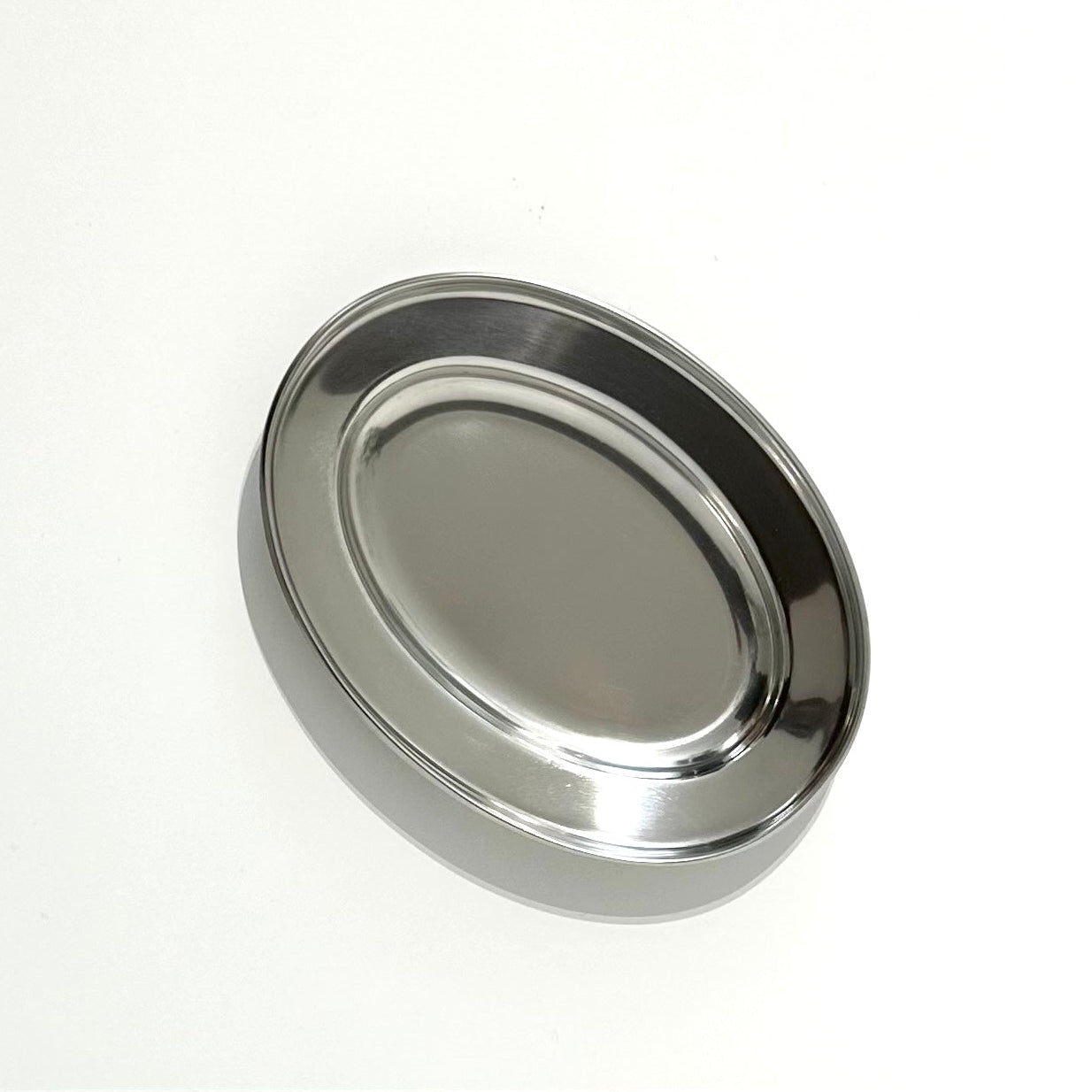 Oval stainless steel serving dish on white background