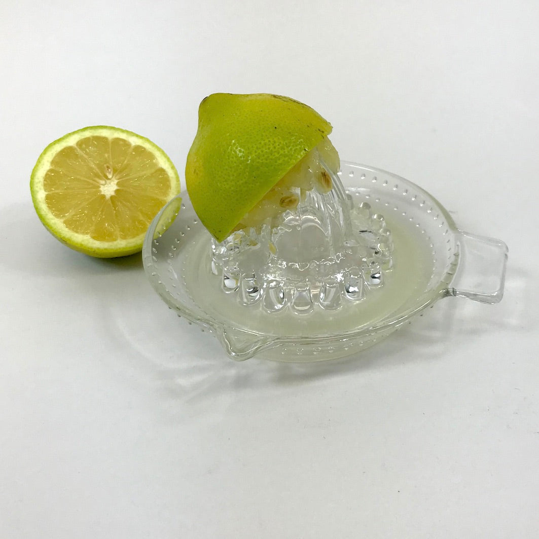 Glass lemon squeezer juicer with lemon
