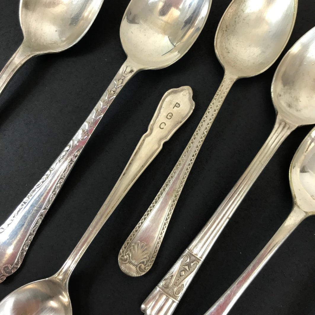 Silver plate teaspoons detail black bg