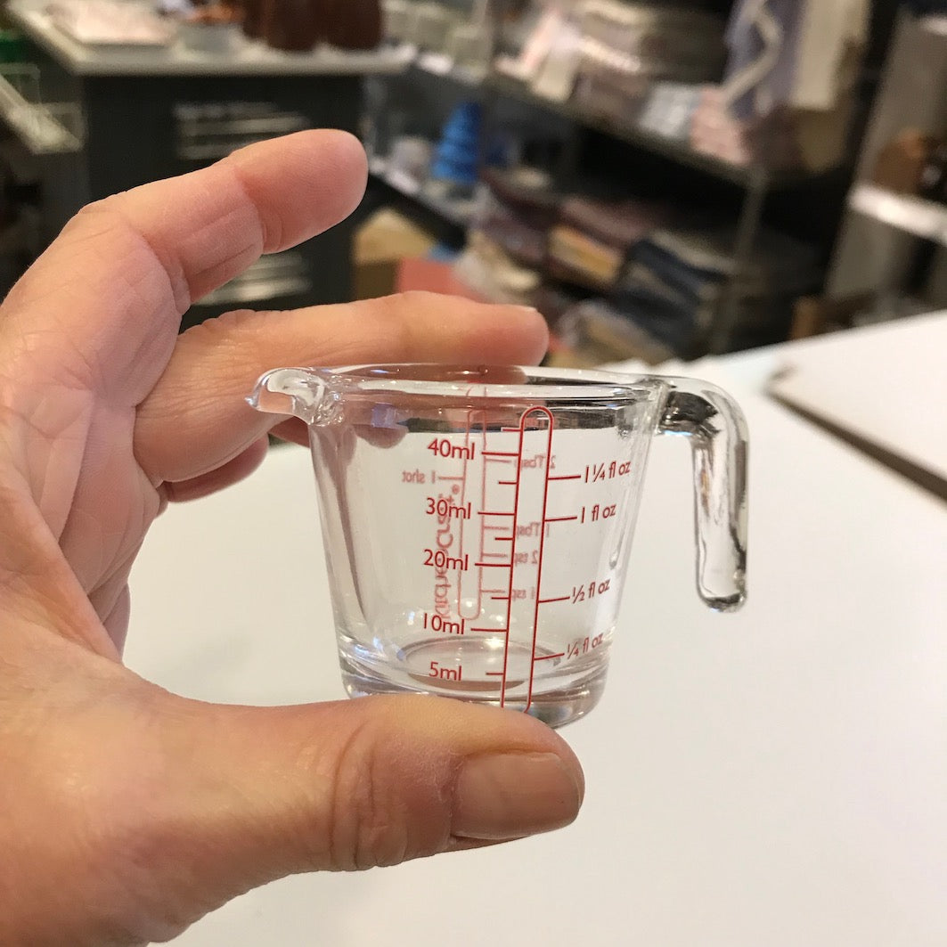 Tiny measuring jug hand for scale
