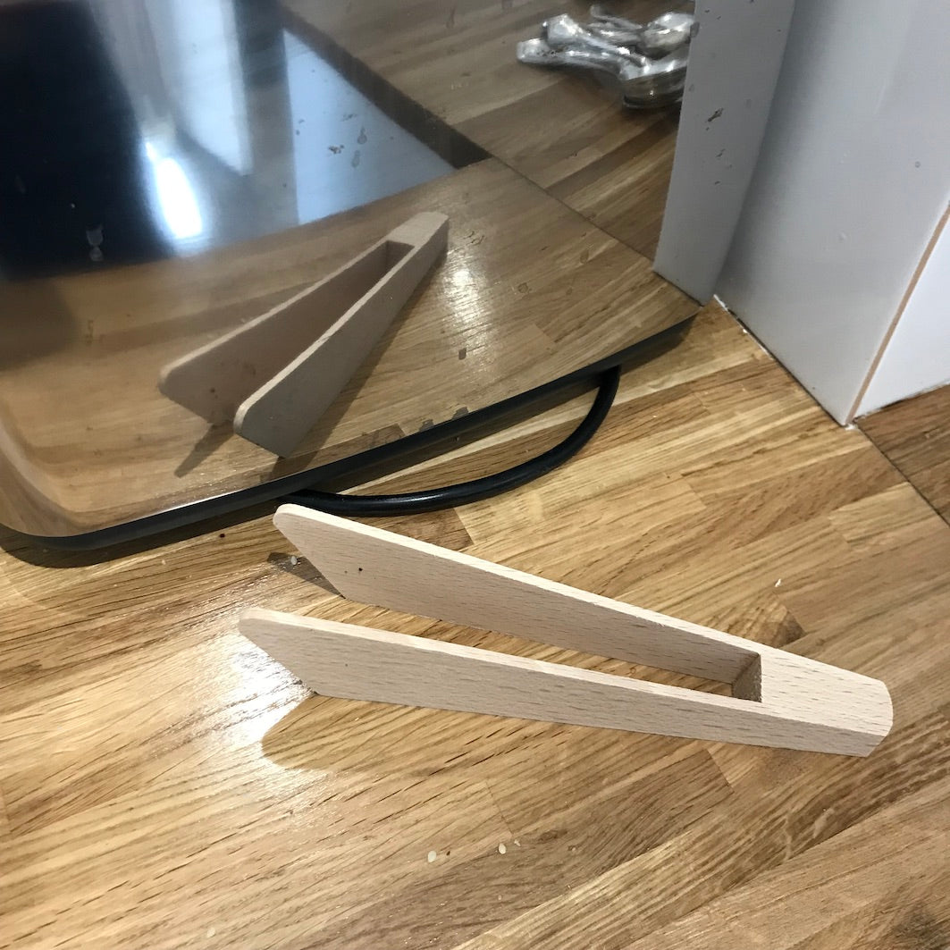 Wooden toast tongs toaster reflection