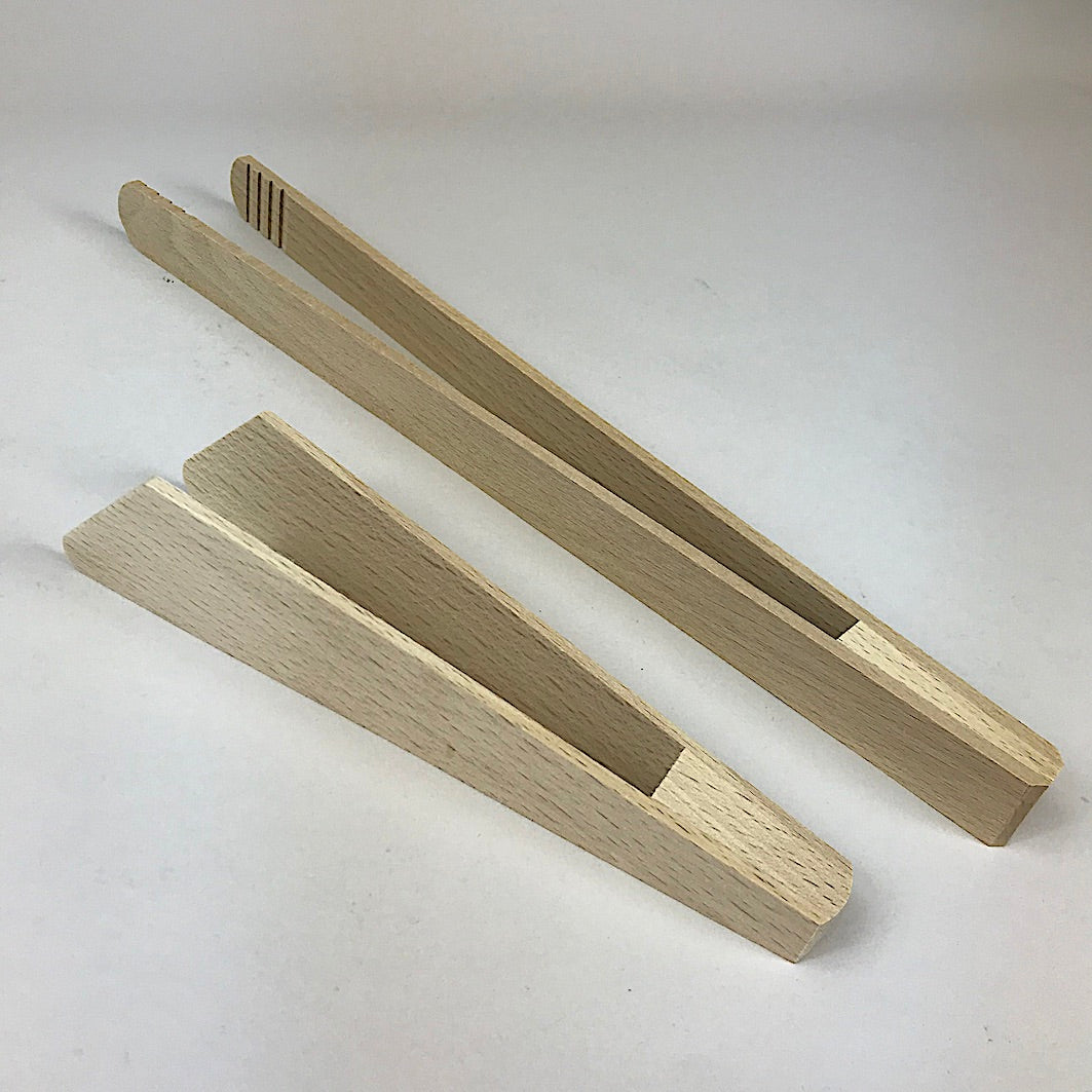Wooden tongs cooking and toast