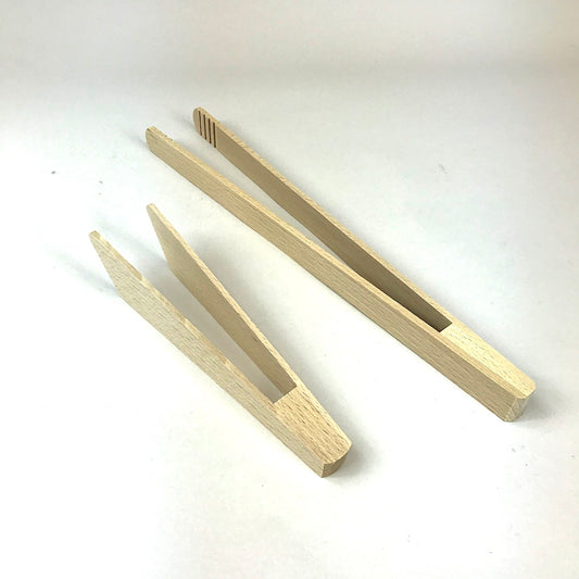 Wooden tongs toast and cooking